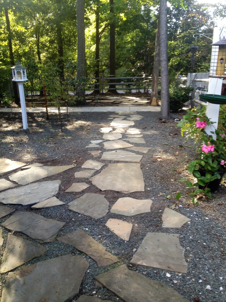 This custom hardscape design includes a rock walkway